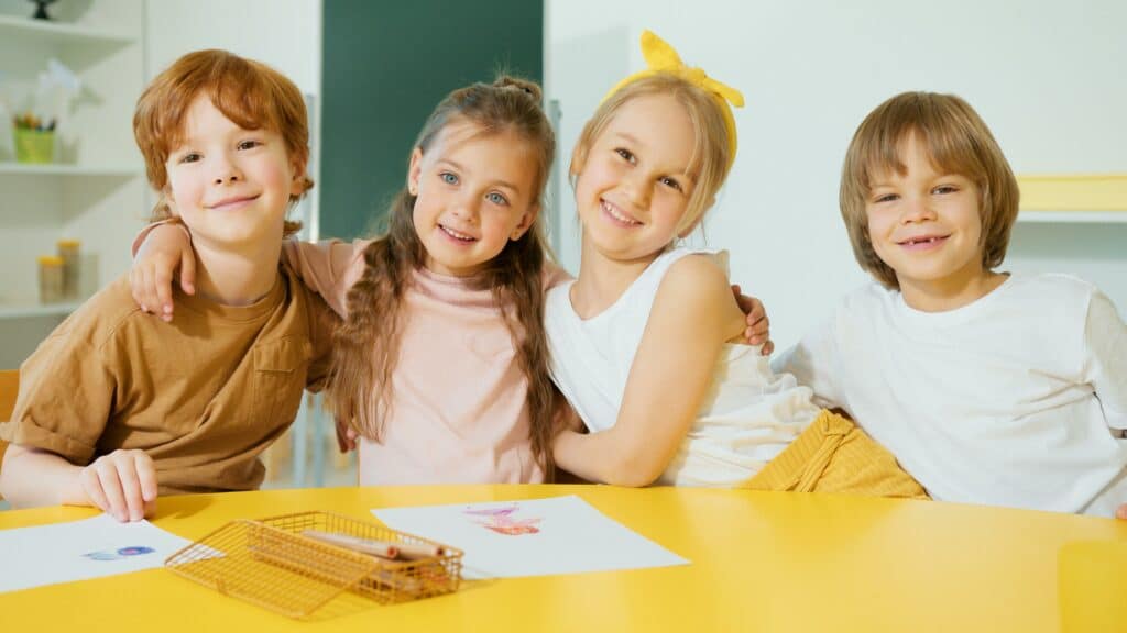 group of kids in an elementary classroom at yellow table