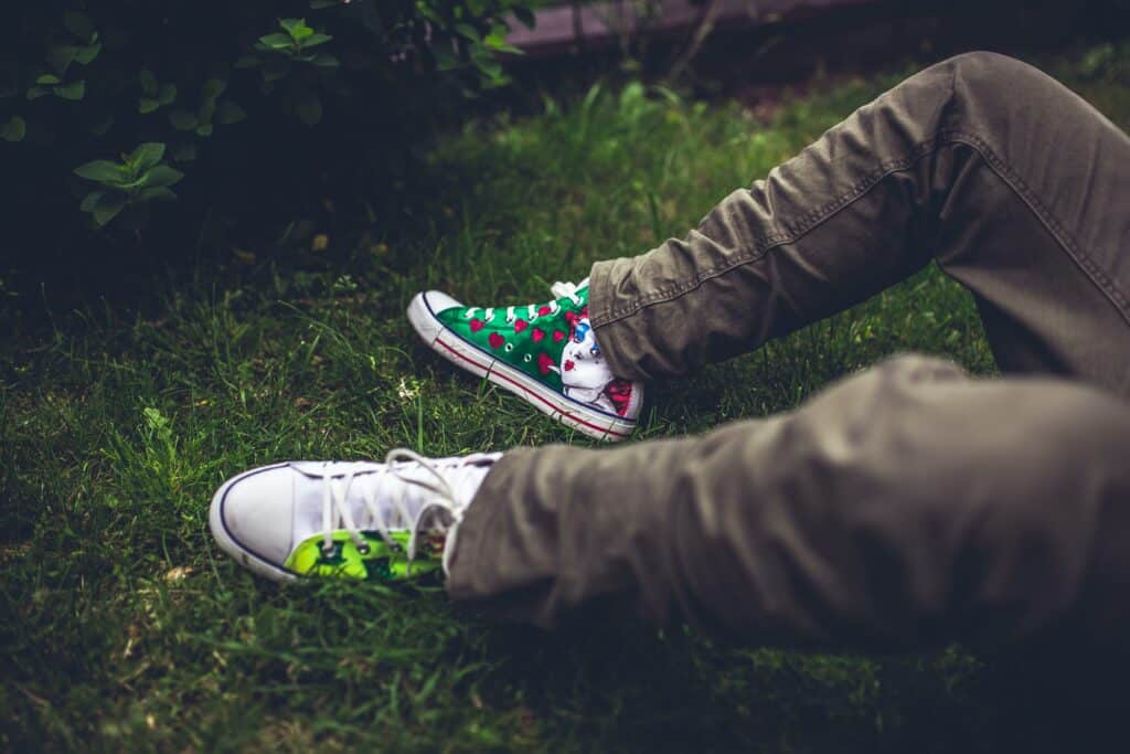 teen boy with different colored shoes