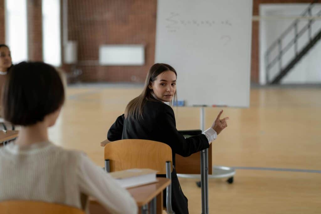 student looking behind herself in a classroom