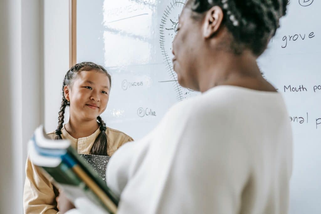 student smiling at her teacher