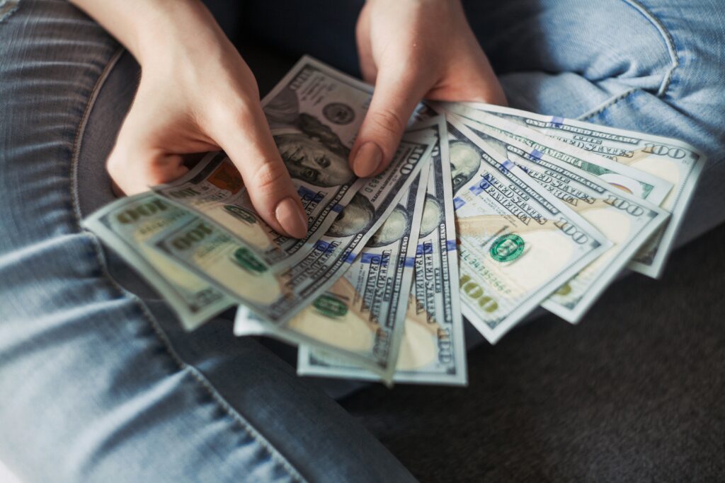 student with dollar bills in hands