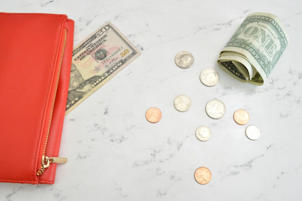 coins and dollars on table